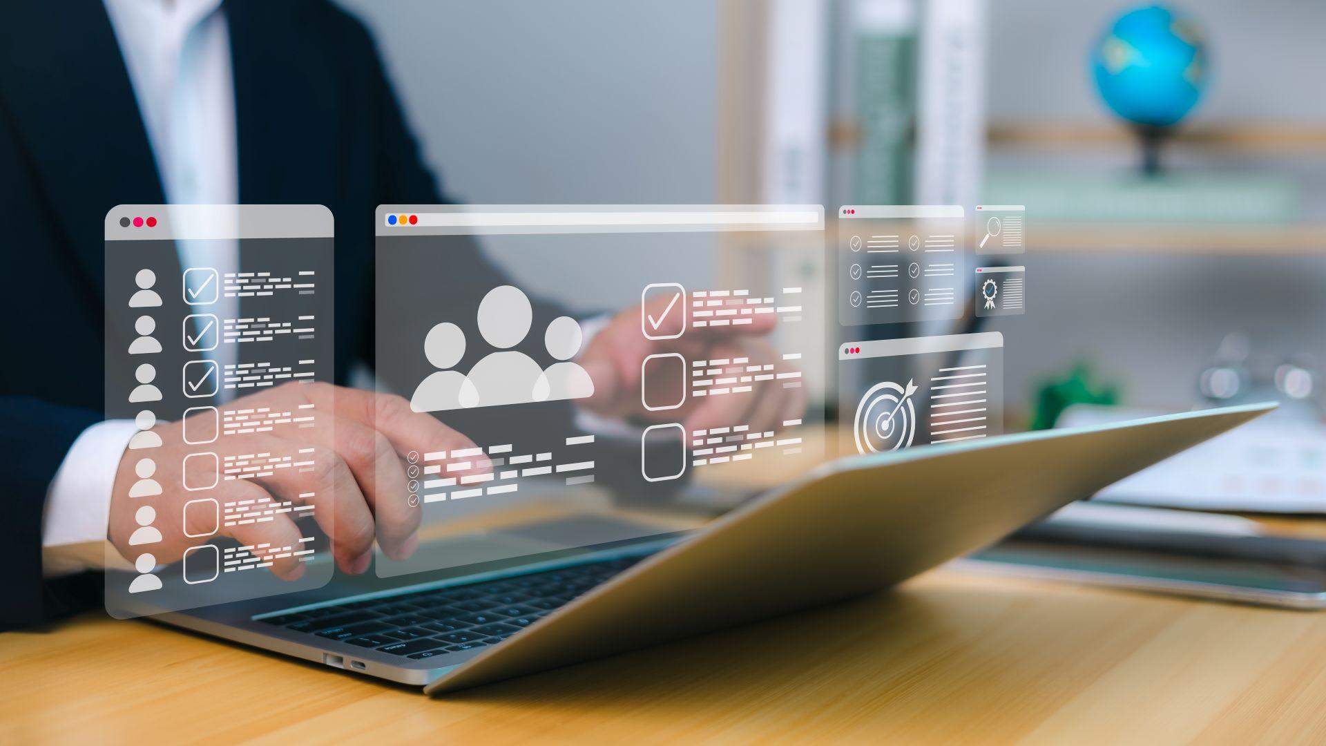 Hands typing on laptop with digital data icons